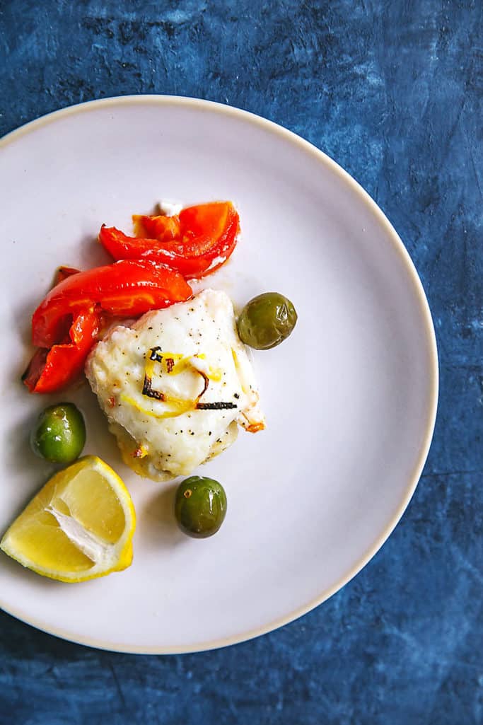 This roasted haddock with tomatoes and olives can be made in one pan. It's salty and sweet and super easy! Whole30/paleo too!